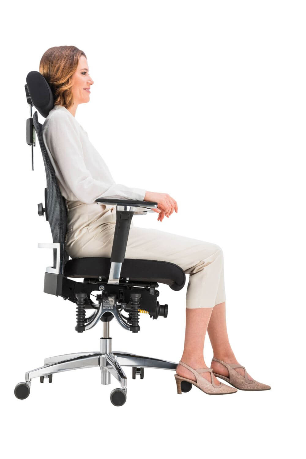 Frau sitzt ergonomisch auf einem Bürostuhl mit Kopfstütze und verstellbaren Armlehnen, demonstriert dynamisches Sitzen.