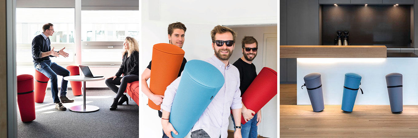 Menschen interagieren mit bunten ergonomischen Stehhilfe Wilkhahn Stand-Up in einem modernen Büro- und Loungebereich.