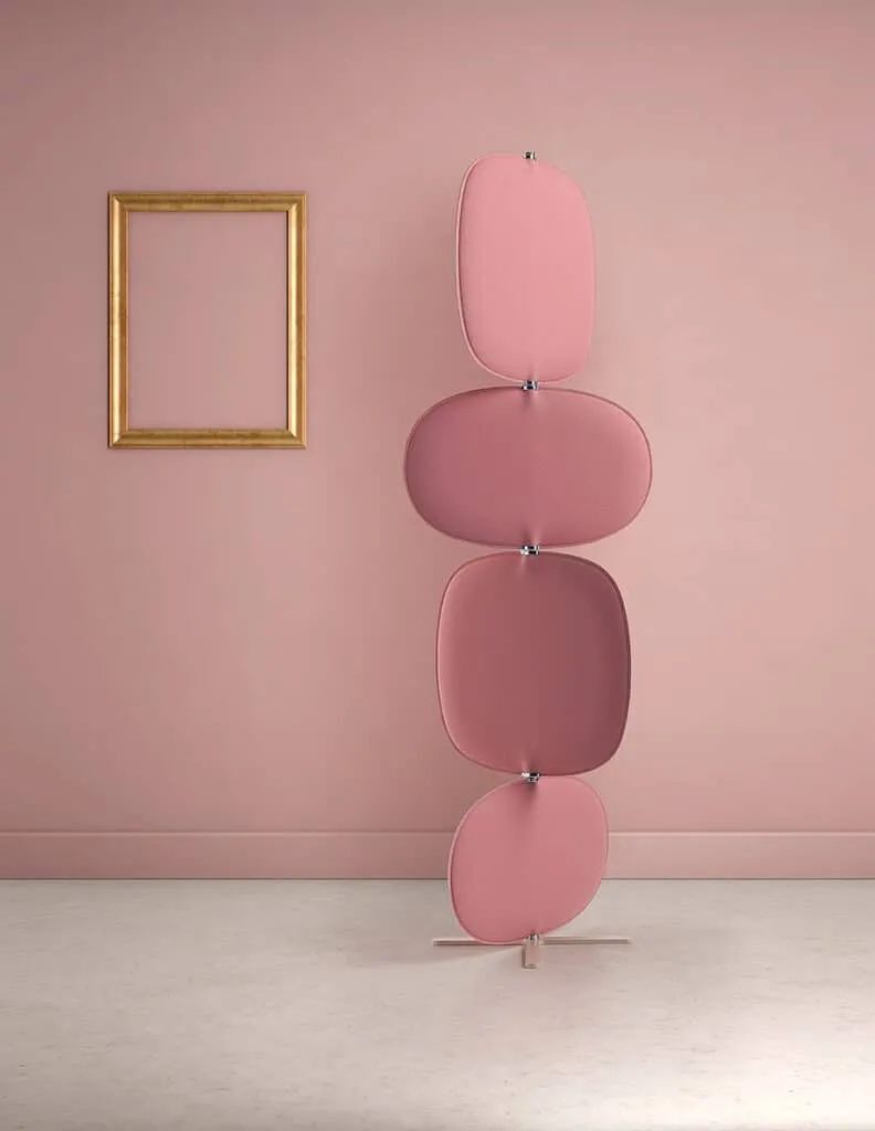 Moderner rosa Raumteiler mit vier Paneelen, daneben ein goldener leerer Rahmen an der Wand.